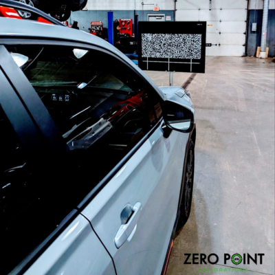 ADAS Calibration Services being performed by Zero Point Calibrations on a white vehicle.