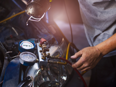 A technician performing Vehicle HVAC Repair Services.