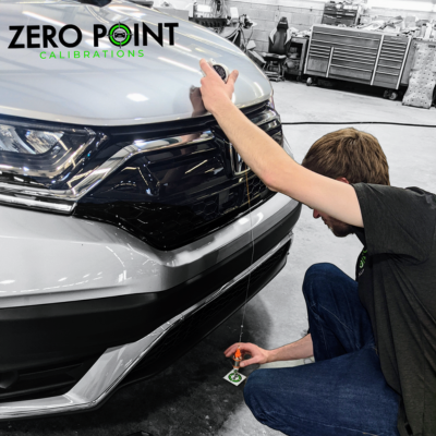 Zero Point Calibrations expert technician performing calibration services on a vehicle.